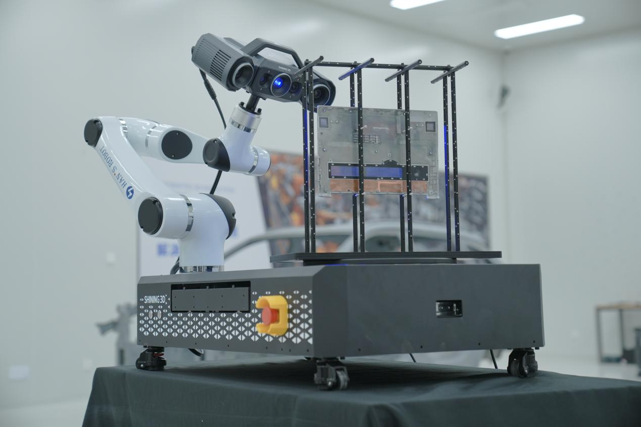 Robotic automated inspection system inspects laptop cases on the production line